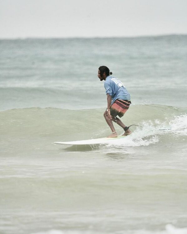 Intermediate surfer on green wave